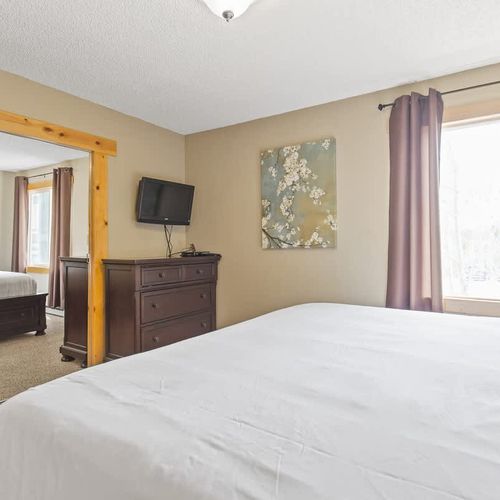 Primary bedroom with king bed and TV