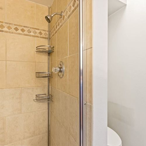 Private full ensuite primary bathroom with walk-in glass shower