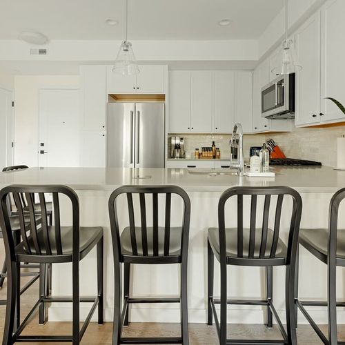 Kitchen has 6 bar stools