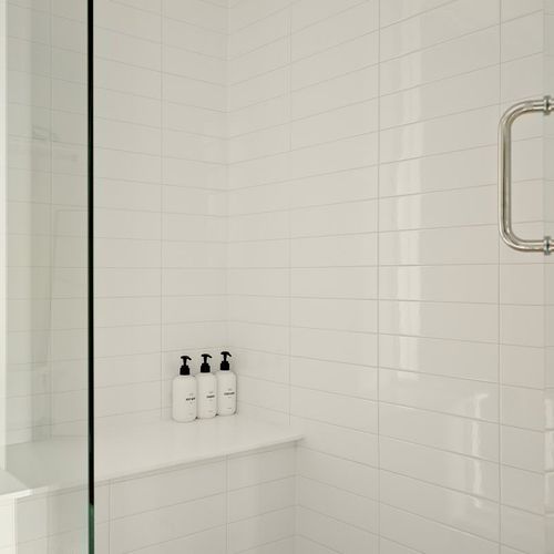 En suite bathroom has a large glass walk-in shower