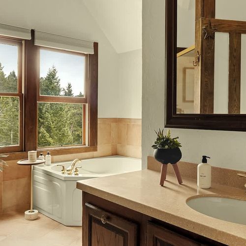 Full ensuite primary bathroom with soaking tub (shared with bedroom 2)