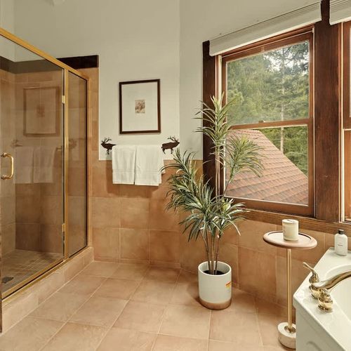 Full ensuite primary bathroom with walk-in glass shower (shared with bedroom 2)
