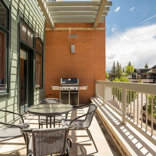 Balcony with seating and gas grill