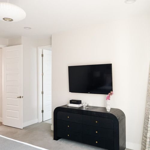 The primary bedroom has a Smart TV