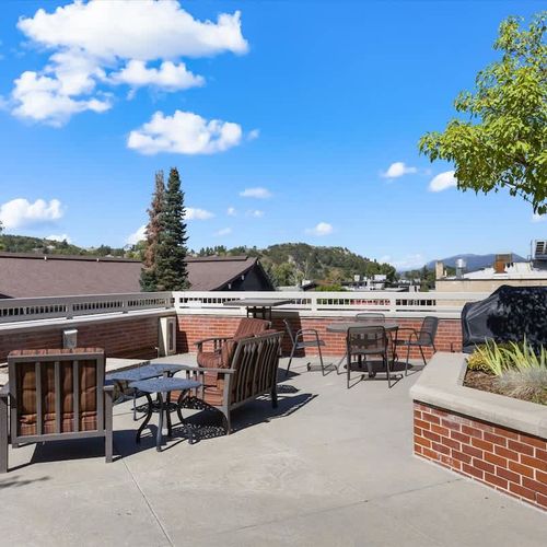 Community patio with fire pit and grill