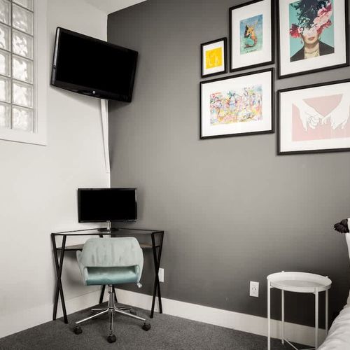 3rd floor bedroom has a Smart TV and desk with monitor