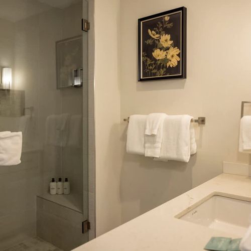 Primary bedroom's private full ensuite bathroom with walk-in glass shower