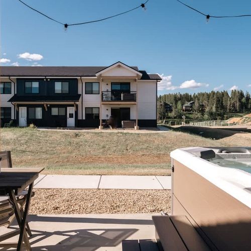 Patio with seating and hot tub