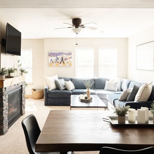 Living area with gas fireplace, smart TV, and large sectional sofa with a pullout full-size bed