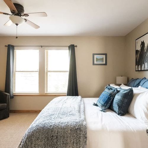 Primary bedroom with seating area and king bed