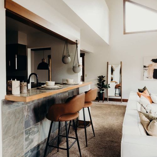 Living room with bar-style seating at the kitchen counter