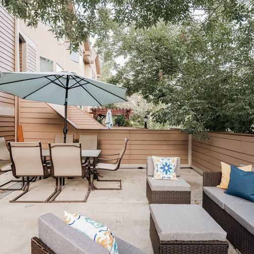Front patio with outdoor dining table with umbrella