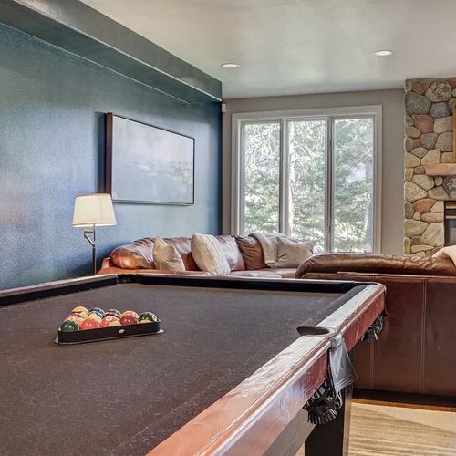 Pool table in game room leading into living area 2 *Please note the lower level fireplace is not currently working*
