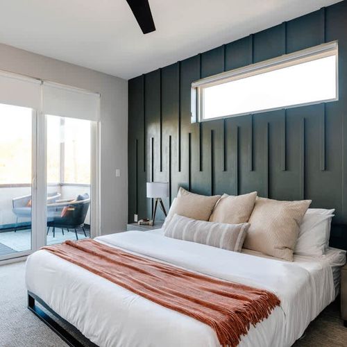 King primary bedroom with balcony