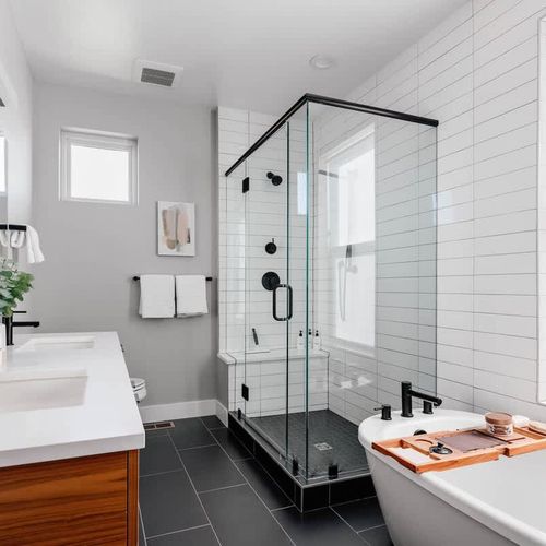 Primary ensuite bathroom with standing shower and free-standing tub