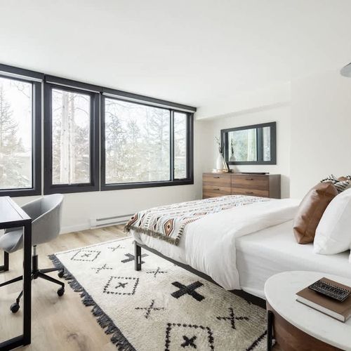 Bedroom has a king bed with workspace