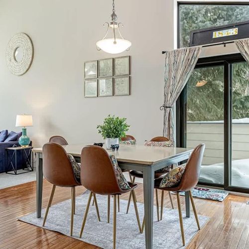 Behind the dining table is a sliding door leading to the balcony