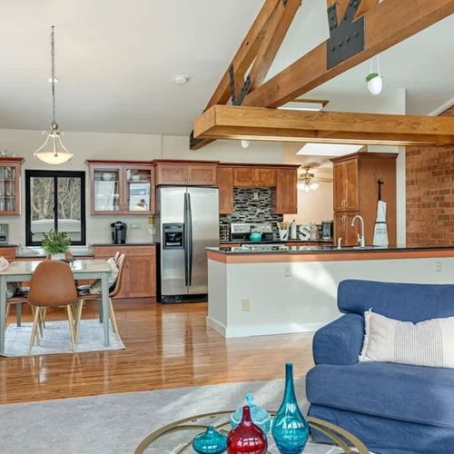 The living, dining, and kitchen areas comprise the entire top floor of the unit.