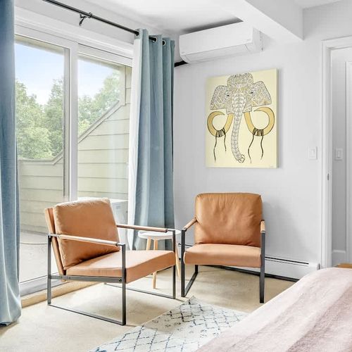 Two chairs and a balcony in the primary bedroom suite