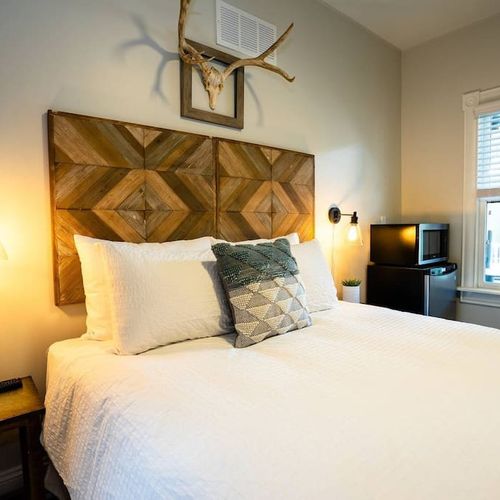 The room includes a microwave and mini fridge