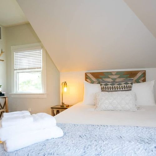 The room includes a queen sized bed