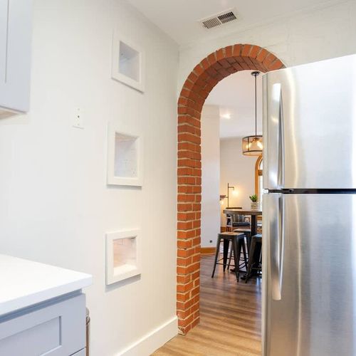 The open layout allows whoever is in the kitchen to have a conversation with the people sitting at the dining table.