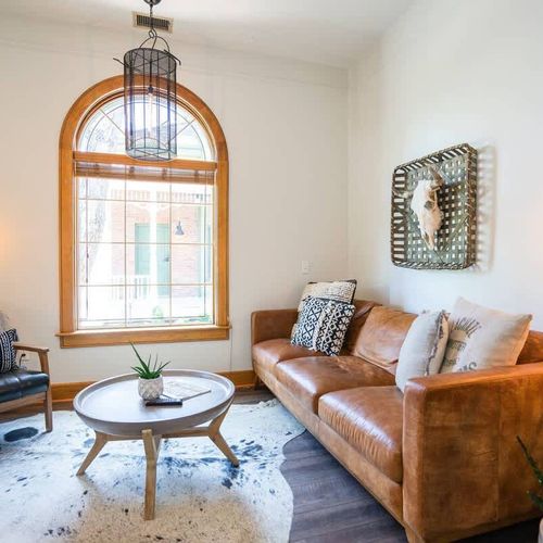 The living area is a comfortable, stylish area that includes a couch, chair and fireplace.