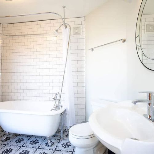 The bathroom fills with an abundance of light and has a beautiful clawfoot bath tub.