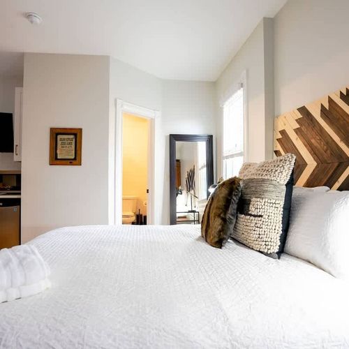 The room includes a queen sized bed