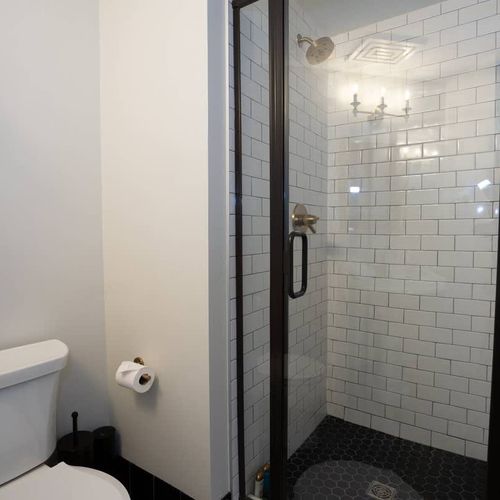 The room includes a full bathroom with a shower.