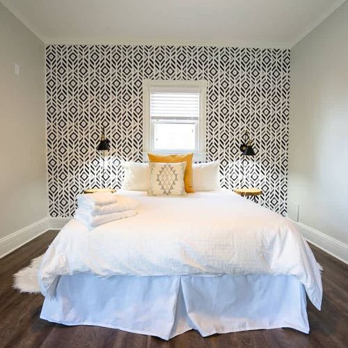 The room features a plush queen bed.