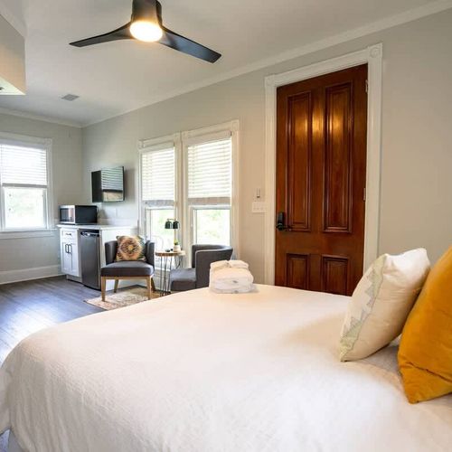 The room has its own seating area and mini kitchenette.