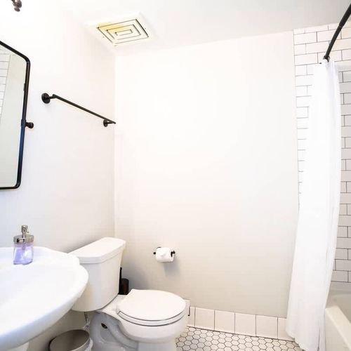 The private bathroom features a shower + bath tub