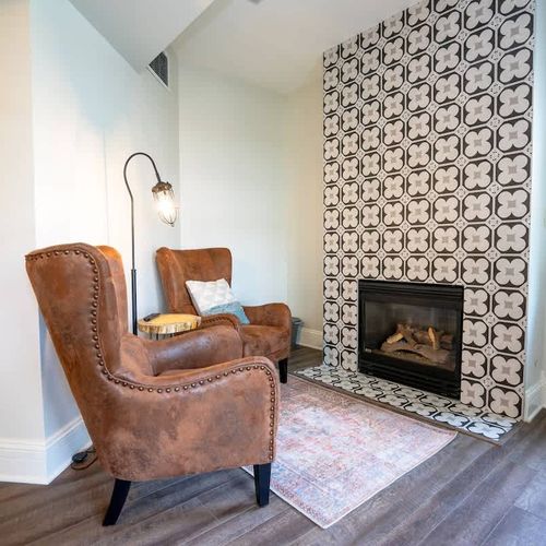 The room has a seating area next to a fireplace