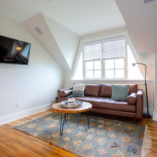 The sitting area is next to the fireplace and includes a TV