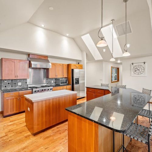 Large, gourmet kitchen with island and breakfast bar seating.