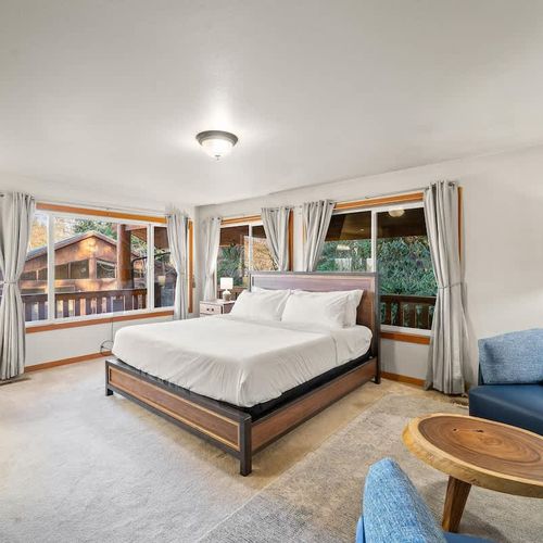 Primary bedroom on main level, with King bed, fireplace and walkthrough bathroom.
