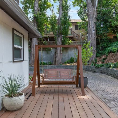 Welcome to your cozy nook: our porch swing, where simple pleasures meet tranquil moments.