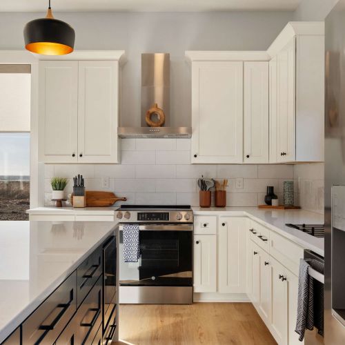 Full size stove, open shelves, and full cookware - set up for real cooking and casual meals.