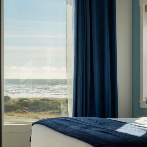 Wake up to the waves—ocean views right from bed in this bright upstairs room.