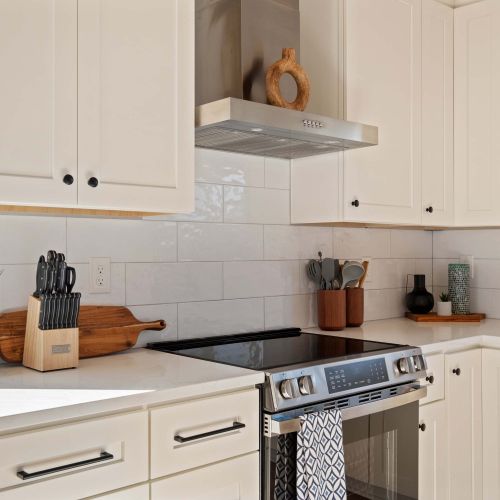Fully stocked kitchen with coffee gear, pots, pans, and quality appliances.