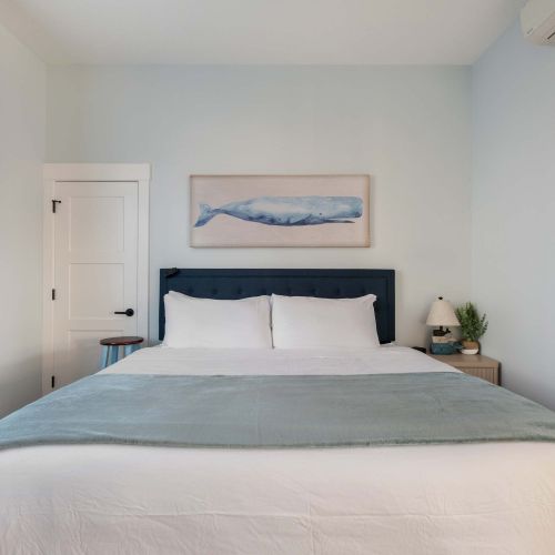 Bright and relaxing king bedroom—simple and peaceful with easy access.