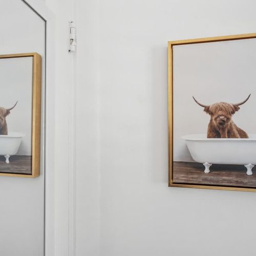 Unwind in style in this chic bedroom with bold blue walls that inspire tranquility and calmness for a restful night’s sleep.