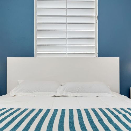 Rest easy in this vibrant bedroom featuring modern aesthetics, ensuring every moment spent is one of comfort and serenity.