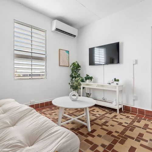 Indulge in the comfort of our spacious living room, accentuated by modern furnishings and vibrant decorative touches.