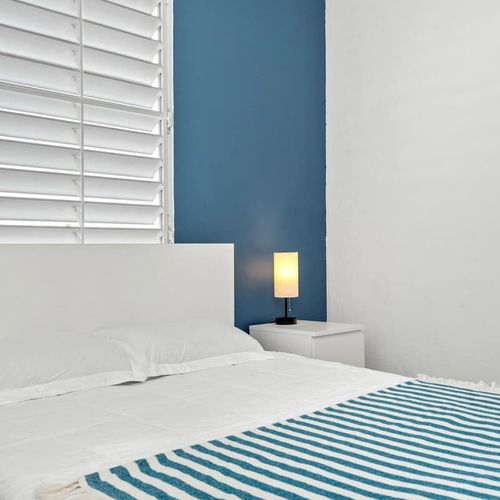 Enjoy the blend of modern design and comfort in this spacious bedroom, promising restful nights and energized mornings.