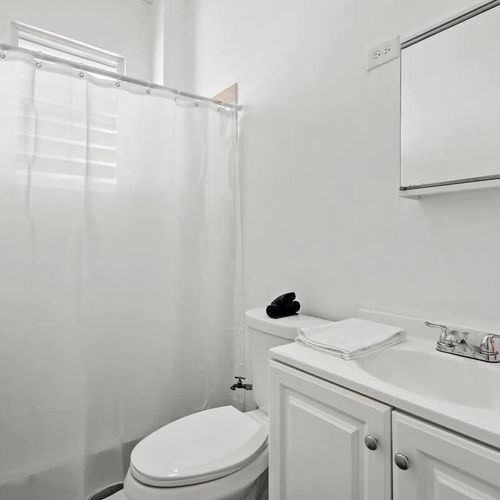 Indulge in tranquility within our pristine white bathroom, offering a serene escape from the hustle and bustle of the day.