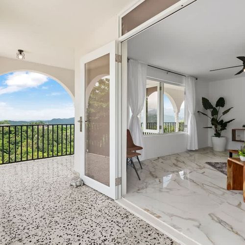A spacious open-plan living area with marble flooring.