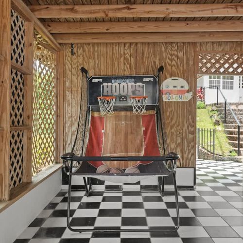 bbq area with dining table, outdoor kitchen and straight access to the pool and basketball arcade