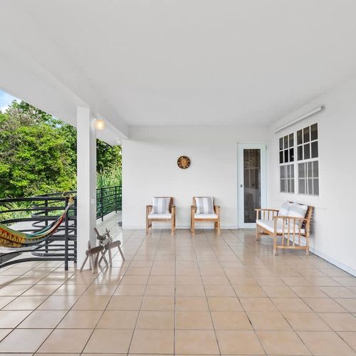 An open terrace with views with  comfortable sofas and a large hammock,